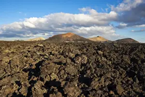Arid Landscapes Prints: Irregular blocky lava (Hawaiian term: a a) and cinder cones of the volcanic landscape of Timanfaya National Park