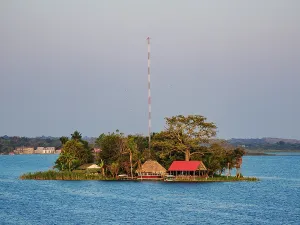 Small Prints: Islet surrounded by water near Flores in Guatemala with a tall structure on the land