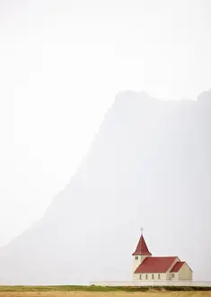 Hazy Prints: Isolated church with hazy outline of distant mountain in the background