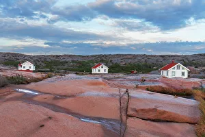 Gotaland Prints: Three isolated houses on red granite island at dusk