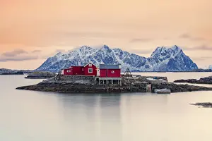 Svolvaer Prints: Isolated red fishermens cabins on rocks in the cold sea at sunset