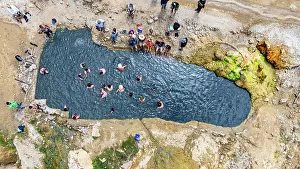 Swimming Prints: Istisu hot springs seen from above with people enjoying water in Qarabaqh