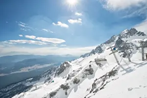Jade Dragon Snow Mountain with blue cable cars and view on the lower regions of Yunnan, China, Asia