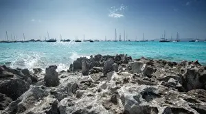 Sailboats Prints: Jagged rocks with sailboats idling in the azure waters of Formentera, Balearic Islands
