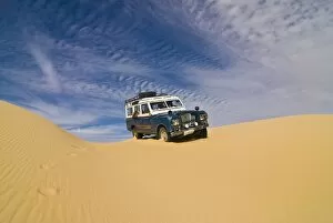 Jeep driving through the high sand dune of the Western Desert, near Siwa