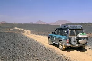 Images Dated 26th April 2005: Jeep driving on stone desert, Akakus, Sahara desert, Fezzan, Libya, North Africa, Africa