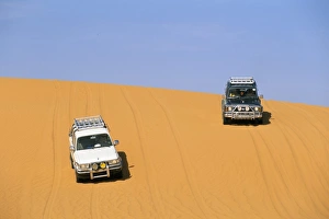 Arid Landscape Prints: Jeeps on sand dune, Akakus, Sahara desert, Fezzan, Libya, North Africa. Africa