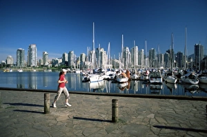 False Creek Prints: Jogger passing in front of False Creek marina, with downtown skyscrapers behind