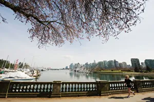 Images Dated 4th April 2009: Jogger running on the waterfront in Coal Harbour, Vancouver, British Columbia