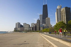 Images Dated 13th May 2008: Joggers and cyclists on Lake Michigan shore with the Near North skyline behind