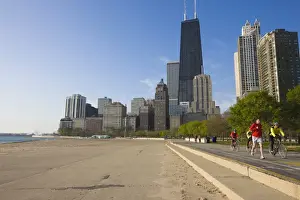 Lake Michigan Prints: Joggers and cyclists on Lake Michigan shore with the Near North skyline behind