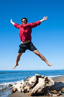 Jumping close to sea, Capalbio beach, province of Grosseto, Tuscany, Italy, Europe Jumping close to sea, Capalbio beach, province of Grosseto, Tuscany, Italy, Europe