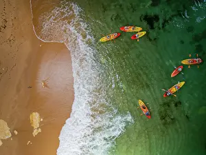 Activities Prints: Kayaking at Algar de Benagil cave in Carvoeiro Algarve Portugal with colorful boats and clear water