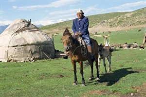 Yurt Prints: Kazak woman on horseback beside a yurt in the Altay mountains, north east Xinjiang