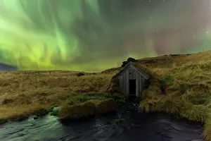 Sudurland Prints: Keldur old mill turf house and hills lit by Northern Lights (Aurora Borealis)