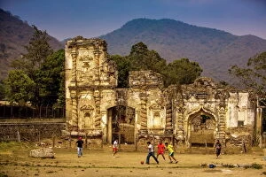 Ruined Gallery: Kids playing soccer at ruins in Antigua, Guatemala, Central America