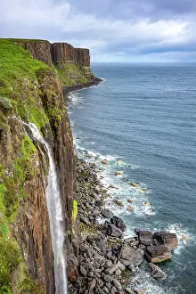 Kilt Prints: Kilt Rock waterfall pours down cliffs into the sea on the Isle of Skye in Scotland on a cloudy day
