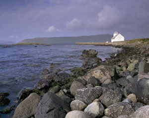 Images Dated 21st September 2009: Kirkjubour, church and rocky shoreline, Hestur in the distance, Streymoy