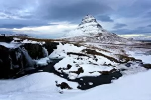 Snaefellsnes Peninsula Gallery: Kirkjufell (Church Mountain) covered in snow with a frozen river and waterfall in the foreground