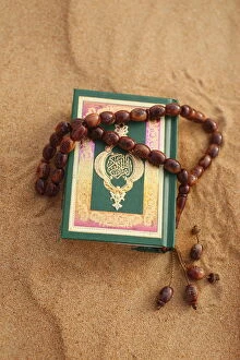 Koran and prayer beads in sand, Dubai, United Arab Emirates, Middle East