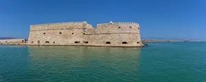 Venetian Prints: Koules Venetian Fortress stands in clear waters under a sunny sky in Crete, Greece