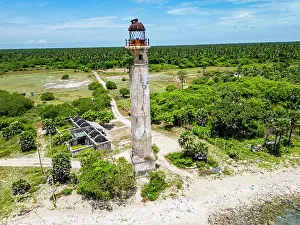 Maritime Prints: Kovalim lighthouse stands tall amidst green landscape near coast in Jaffna district