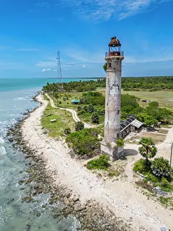 Tall Prints: Kovalim lighthouse stands tall on the coast of Jaffna district in Sri Lanka with turquoise waters in the background