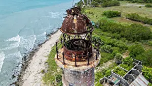 Land Prints: Kovalim lighthouse stands tall on the shoreline with waves crashing nearby in Jaffna district Sri Lanka
