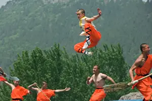 Young Men Prints: Kung fu students displaying their skills at a tourist show within Shaolin Temple