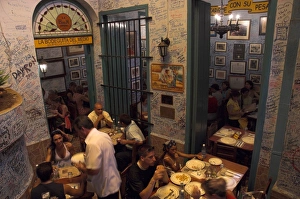 Old Havana Prints: La Bodeguita del Medio restaurant, with signed walls and people eating at tables