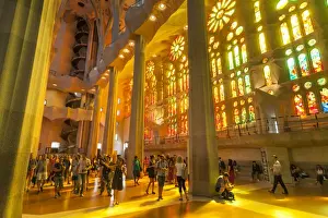 La Sagrada Familia church, basilica interior with stained glass windows by Antoni Gaudi