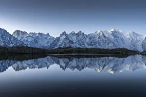 French Alps Prints: Lacs des Cheserys lake and peaks of Mont Blanc massif covered with snow at night