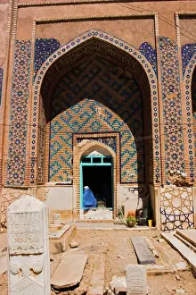 Shrine Prints: Lady pilgrim in blue burqa sitting in doorway at Sufi shrine of Gazargah