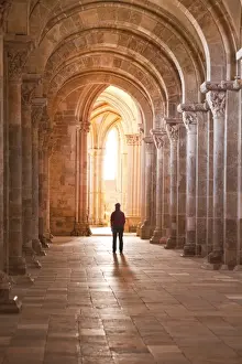 Yonne Prints: A lady slowly walks down an aisle in the Basilique Sainte-Marie-Madeleine of Vezelay