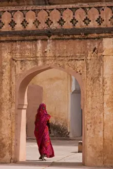 Gateway Prints: Lady in traditional dress walking through a gateway in the Amber Fort near Jaipur
