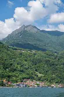 Homes Prints: Lake Como shows mountain scenery with homes and trees along the water in Italy