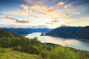 Lake Como Prints: Lake Como surrounded by green meadows framed by pink sky at dawn, Cremia, San Domenico