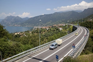 Road Marking Prints: Lake and the S10 road, Lake Iseo, Lombardy, Italian Lakes, Italy, Europe