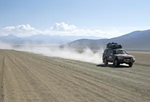 Dusty Prints: Land cruiser on altiplano track with tourists going to Laguna Colorado
