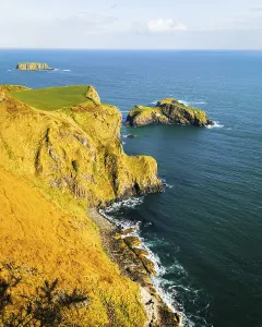 Rock Cliff Prints: Landscape of Burren National Park in Ireland with rugged limestone cliffs and Atlantic Ocean under blue sky