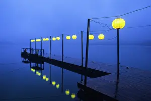 Taiwan Prints: Lanterns line a dock at dusk by Sun Moon Lake in Taiwan creating reflections in the water