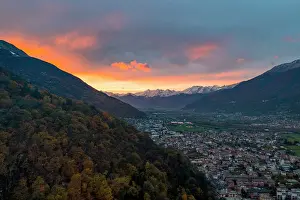 Valtellina Prints: Larch tree woods on mountains surrounding Morbegno town at sunset in autumn