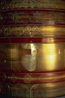 Gold Prints: Large gold and red spinning Buddhist prayer wheels