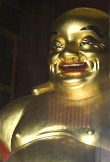 Large golden smiling Buddha in Kek Lok Si Buddhist temple, Air Itam, Georgetown