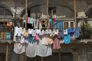 Old Havana Prints: Large quantity of laundry hanging from the balcony of a crumbling building