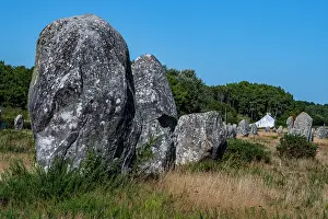 Small Prints: Large standing stones in a grassy field with a small house in the background in France