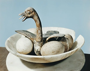 Lid of an alabaster jar decorated with a bird in a nest and eggs in a bowl