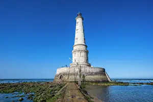 Navigation Prints: Lighthouse at Cordouan in France stands on the coast with clear skies and low tide during daylight