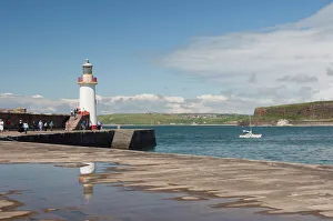 Light House Prints: Lighthouse at entrance to outer harbour, motor yacht entering, Whitehaven