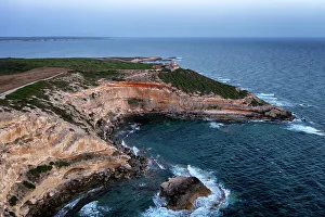 Lighthouse on Mannu Cape wild coast of Sardinia, aerial drone view at sunset, Sardinia, Italy, Mediterranean, Europe